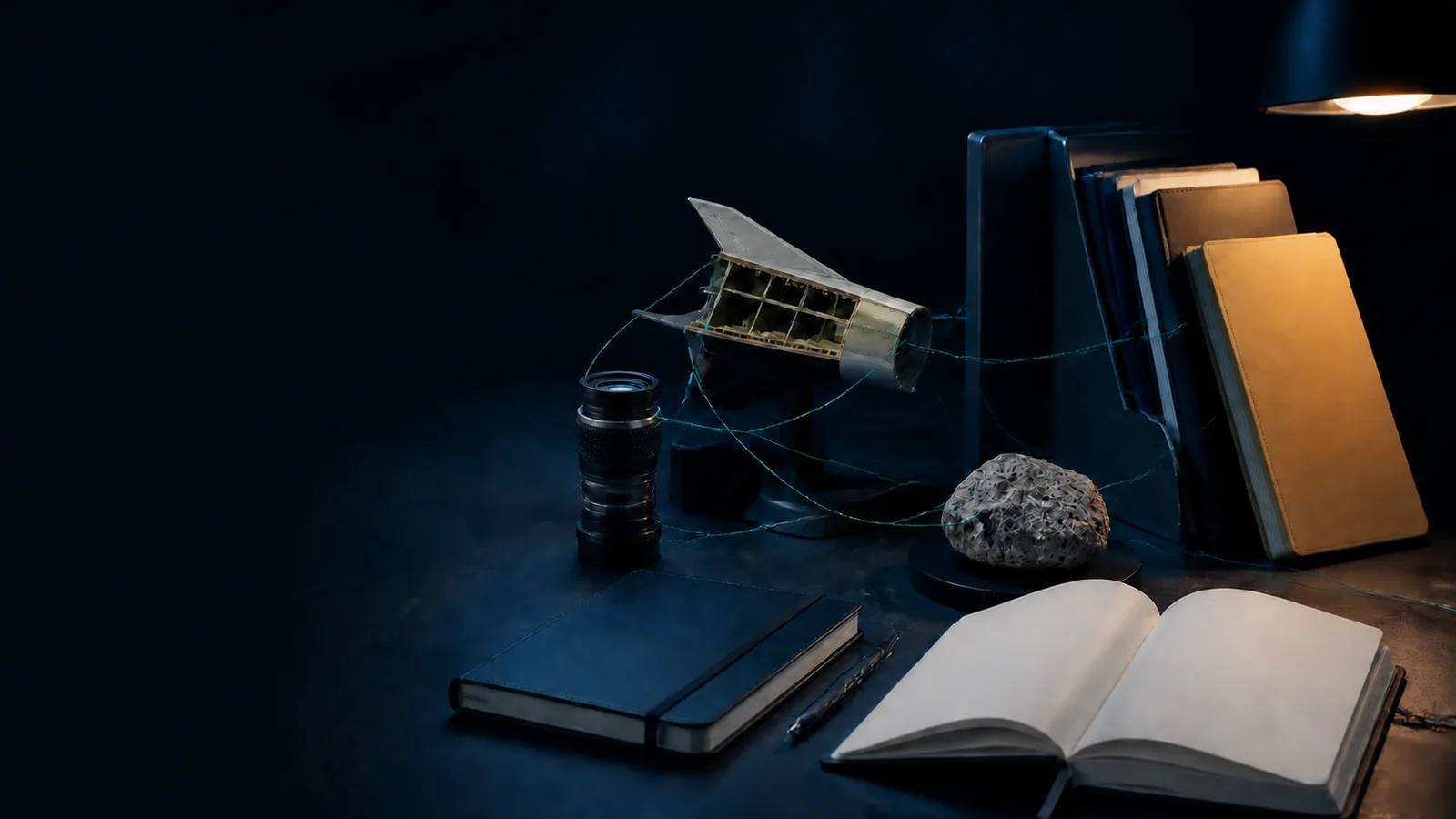 Editorial illustration of a space-studies editor’s desk with optics, engineering components, and orbital sketches.